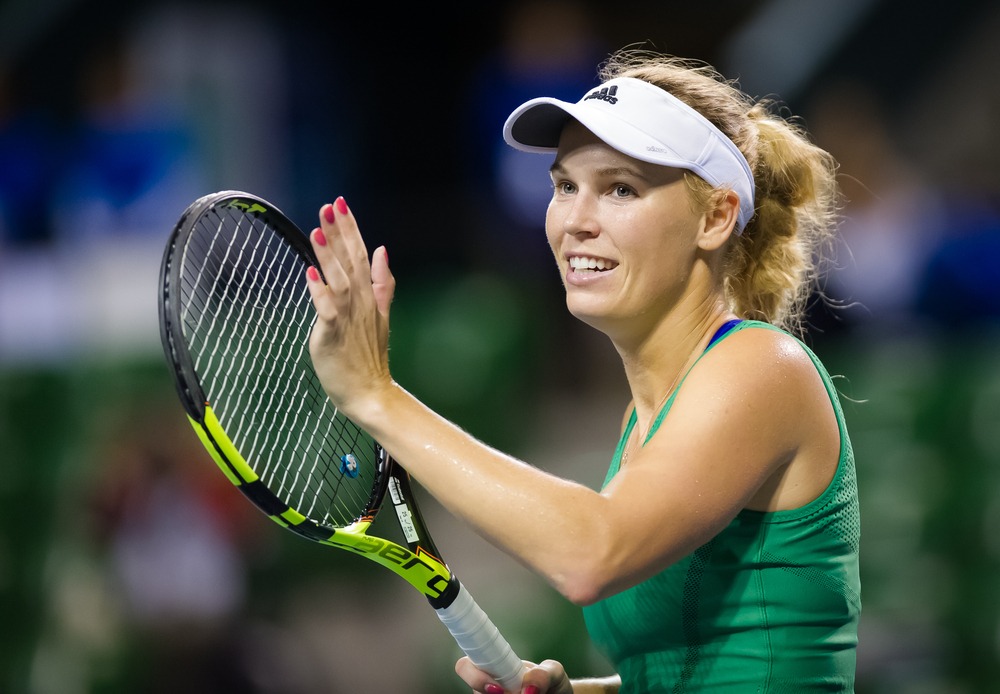 Danske Caroline Wozniacki under en tenniskamp i grøn kjole